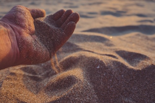 hand pours out sand. high quality photo